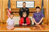 Purple Star School district officials and families attend governor’s proclamation signing for Month of the Military Child